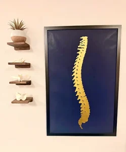 Gold foil wall art of a spine